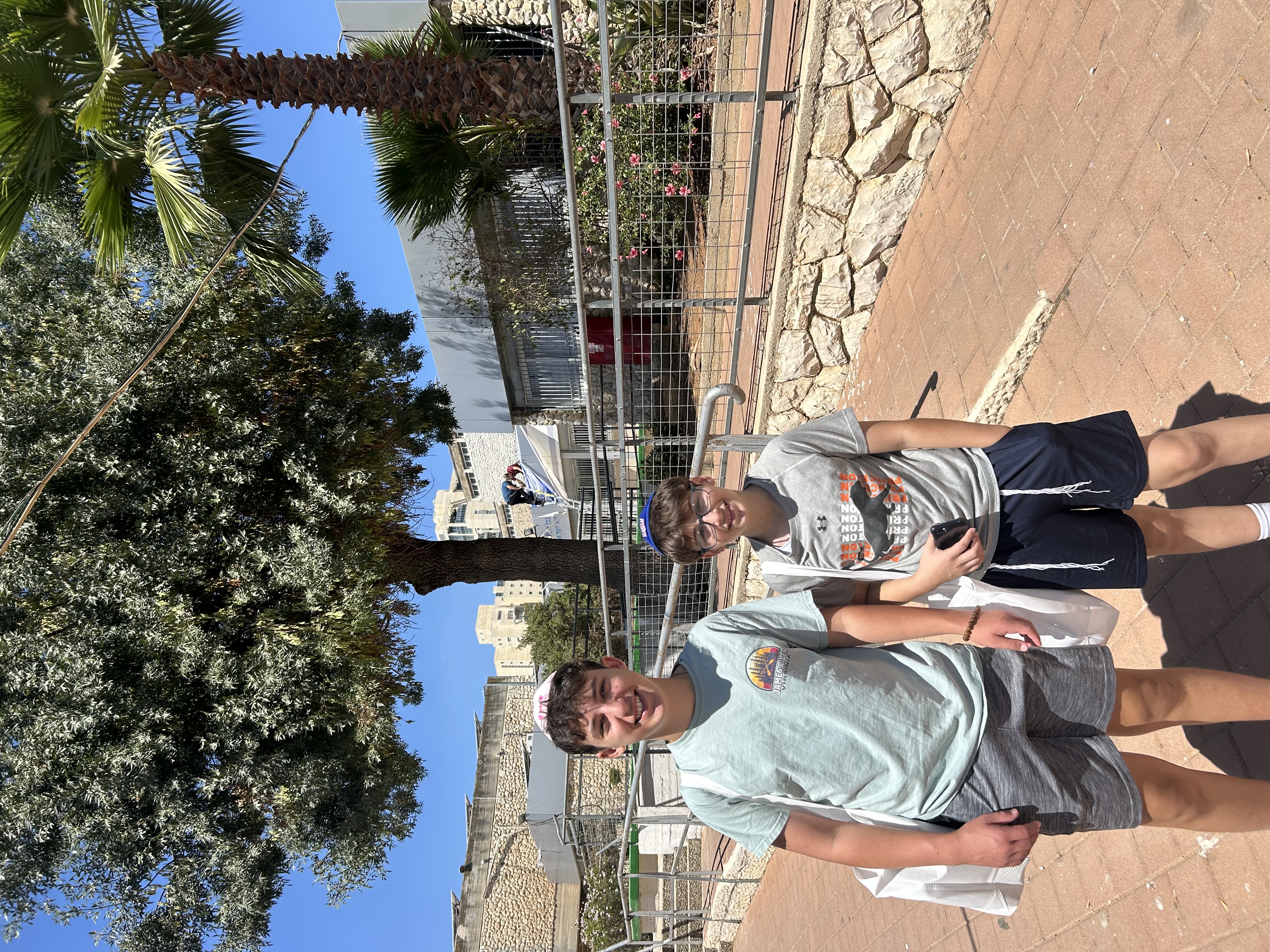 Moshe and Eli outside their new high school, with their textbooks for the year