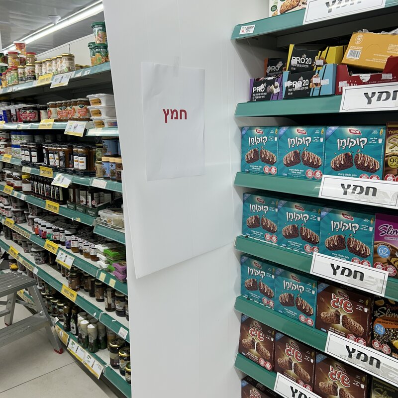 Supermarket changing over for Passover (signs and partitions between the leavened and unleavened products)