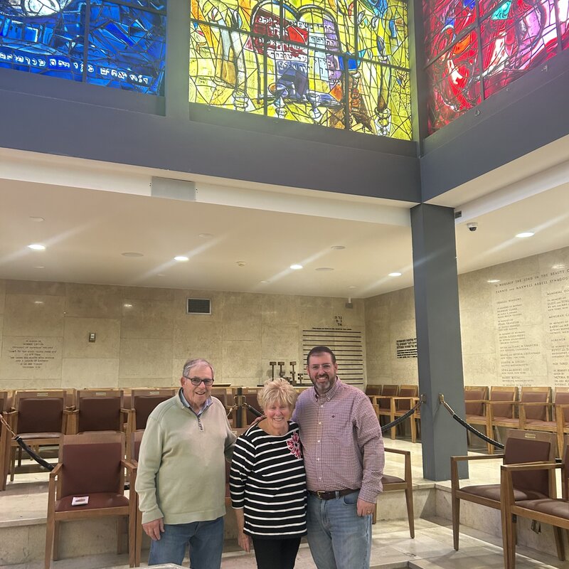 Ted, Karen, and Jonathan beneath the Chagall stained-glass windows
